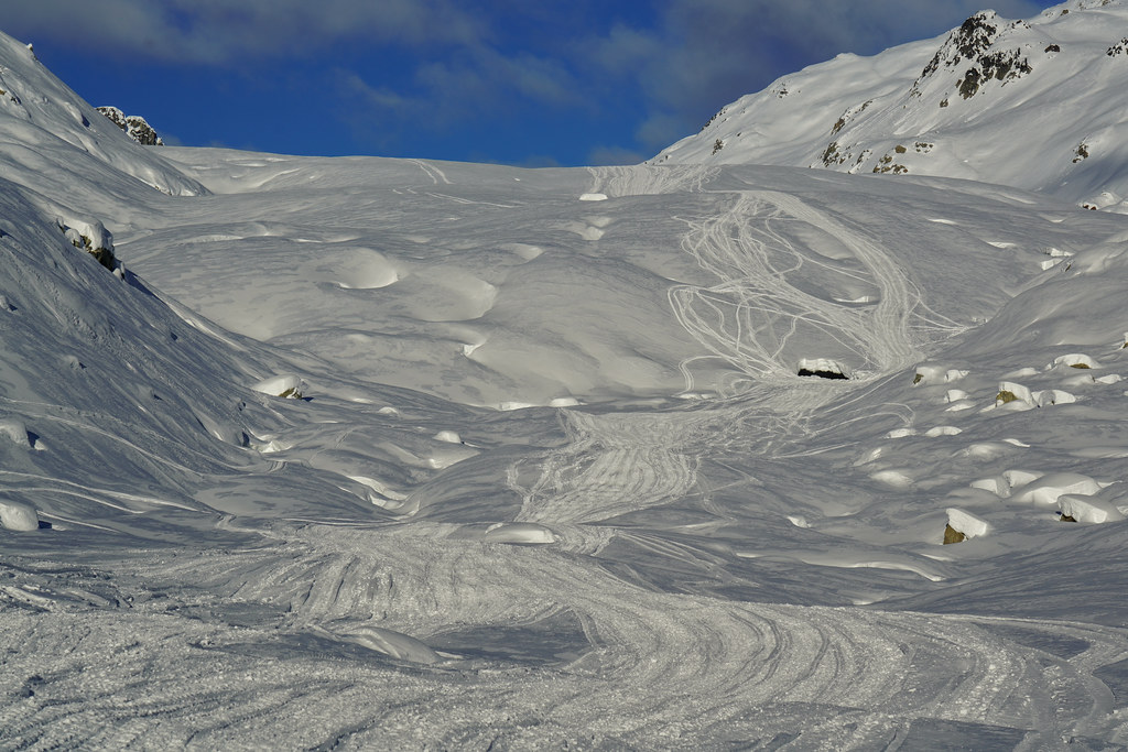 Terminus of the Appa Glacier. The tracks are from snowmobile riders, who are essentially the only ones making it up there in winter. The hole is the ice cave. It looks smale, but the scale is deceptive. It's truck sized.